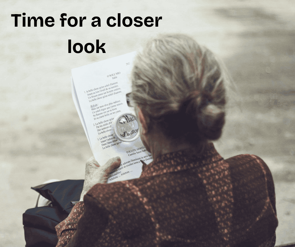 Woman reading with a magnifying glass